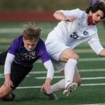 Kamiak's Cade Weatherbie and Meadowdale's River Stewart fall while fighting for the ball during the game on Friday, April 16, 2021 in Mukilteo, Wa. (Olivia Vanni / The Herald)