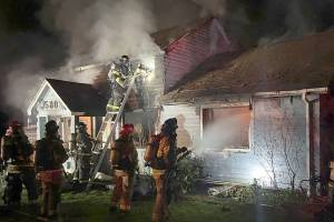 Firefighters work to put out a blaze at a house in the Meadowdale area of Edmonds early Saturday morning.  (South County Fire)