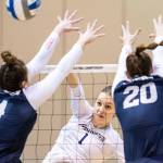 Washington's Lauren Sanders, center, spikes the ball against Dayton's Lexie Almodovar, left, and Lindsey Winner, right, in the third set during an NCAA volleyball tournament in Omaha, Neb., Thursday, April 15, 2021. (Chris Machian/Omaha World-Herald via AP)