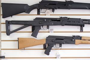 FILE - In this Oct. 2, 2018, file photo, semi-automatic rifles are displayed on a wall at a gun shop in Lynnwood, Wash. Lawmakers in Oregon are considering a proposed gun storage law that would be the among strongest in America (AP Photo/Elaine Thompson, File)