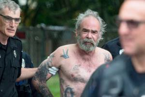 Medics take Jeffrey Phebus, the suspect in a fatal shooting, to an ambulance on McDougall Avenue on Friday, May 24, 2019 in Everett, Wash. (Andy Bronson / The Herald)