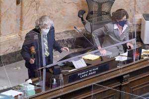 Speaker of the House Laurie Jinkins, D-Tacoma, bangs the gavel during a session of the House, Wednesday, April 21, 2021, at the Capitol in Olympia Wash. Lawmakers were considering a proposed new tax in Washington state on capital gains that would be imposed on the sale of stocks and bonds in excess of $250,000. (AP Photo/Ted S. Warren)