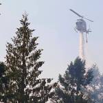FILE - In this Sept. 9, 2020, file photo, a helicopter makes a water drop on a hotspot of a wildfire burning in Bonney Lake, Wash., south of Seattle. A bill to spend $125 million to prevent and fight wildfires in Washington state was passed by the House on Thursday, April 22, 2021, and now will go to Gov. Jay Inslee for his signature. (AP Photo/Ted S. Warren, Pool, File)