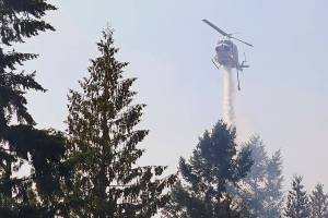 FILE - In this Sept. 9, 2020, file photo, a helicopter makes a water drop on a hotspot of a wildfire burning in Bonney Lake, Wash., south of Seattle. A bill to spend $125 million to prevent and fight wildfires in Washington state was passed by the House on Thursday, April 22, 2021, and now will go to Gov. Jay Inslee for his signature. (AP Photo/Ted S. Warren, Pool, File)