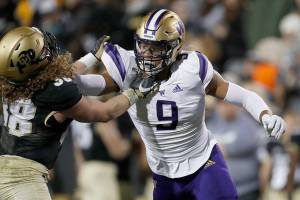Colorado tight end Brady Russell (38) and Washington linebacker Joe Tryon (9) in the second half of an NCAA college football game Saturday, Nov. 23, 2019, in Boulder, Colo. Colorado won 20-14. (AP Photo/David Zalubowski)