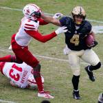 Purdue wide receiver Rondale Moore (4) holds off Nebraska linebacker Will Honas (3) during the first quarter of a game Dec. 5, 2020, in West Lafayette, Ind. (AP Photo/Michael Conroy)