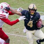 Purdue wide receiver Rondale Moore (4) holds off Nebraska linebacker Will Honas (3) during the first quarter of an NCAA college football game in West Lafayette, Ind., Saturday, Dec. 5, 2020. (AP Photo/Michael Conroy)