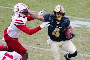 Purdue wide receiver Rondale Moore (4) holds off Nebraska linebacker Will Honas (3) during the first quarter of an NCAA college football game in West Lafayette, Ind., Saturday, Dec. 5, 2020. (AP Photo/Michael Conroy)