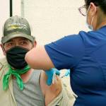 Jose Luis Gonzalez (left) gets his second shot of the Pfizer COVID-19 vaccine from Cecilia Valdovinos on March 25 at the Yakima Valley Farm Workers Clinic in Toppenish. (AP Photo/Ted S. Warren, file)
