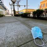 An abandoned face mask rests on the sidewalk along Hewitt Avenue in downtown Everett on April 15. (Sue Misao / The Herald)