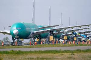 A line of Boeing 777X jets are parked nose to tail on an unused runway at Paine Field, near Boeing's massive production facility, Friday, April 23, 2021, in Everett, Wash.  Boeing Co. on Wednesday, April 28,  reported a loss of $537 million in its first quarter. The Chicago-based company said it had a loss of 92 cents per share. Losses, adjusted for non-recurring gains, were $1.53 per share.  (AP Photo/Elaine Thompson)