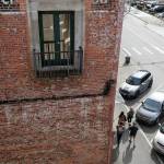 Pedestrians walk beside a brick building on Wetmore Avenue in Everett. Old buildings constructed before 1945, with unreinforced masonry, are vulnerable to seismic waves. The exterior could break away and plummet into the street. (Andy Bronson / The Herald)