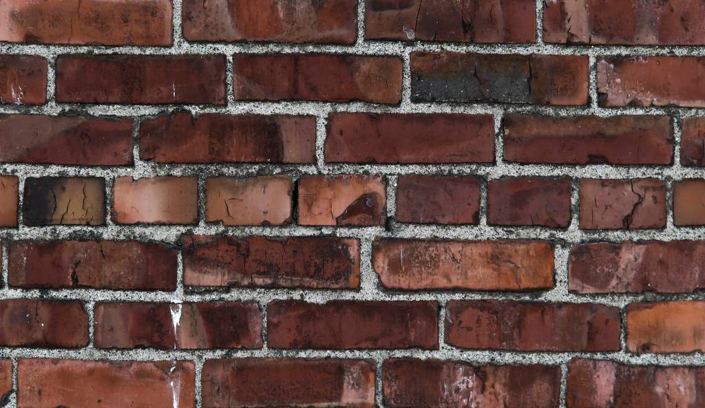 An easy way to spot an unreinforced masonry building is to look for whats called a header course: lines of bricks with the small short end facing out instead of the long end, making stripes in the otherwise homogeneous pattern of a brick wall. A header course can be seen in the center row of a building on Wetmore Avenue in Everett, Washington. (Andy Bronson / The Herald)