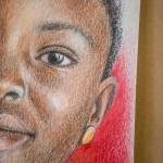Cathy Tanasse uses a variety of colored pencils and colored backgrounds for her Memory Project portraits. (Olivia Vanni / The Herald)
