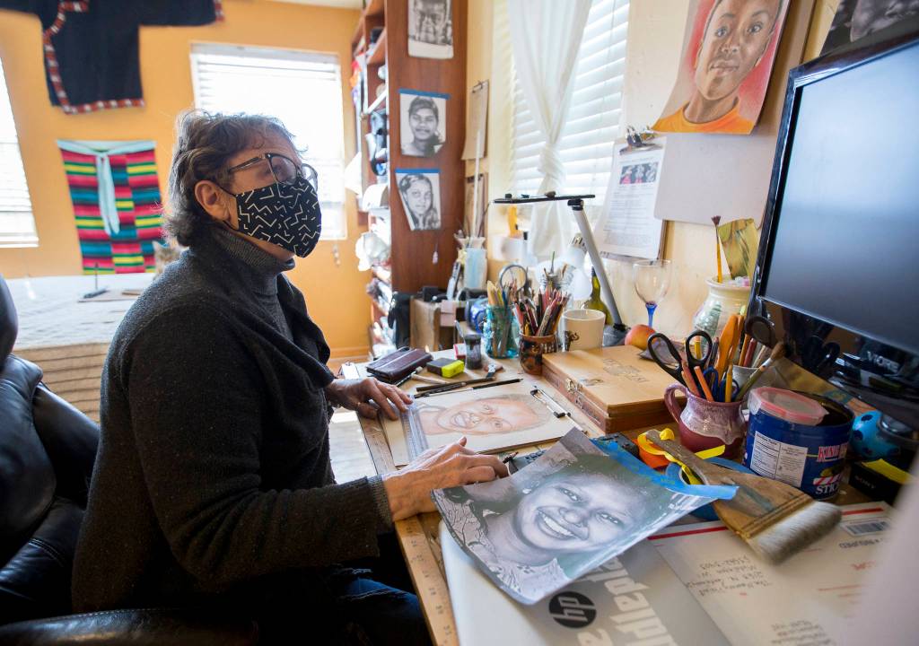 Cathy Tanasse works on a portrait for the Memory Project at her home March 19 in Snohomish. (Olivia Vanni / The Herald)
