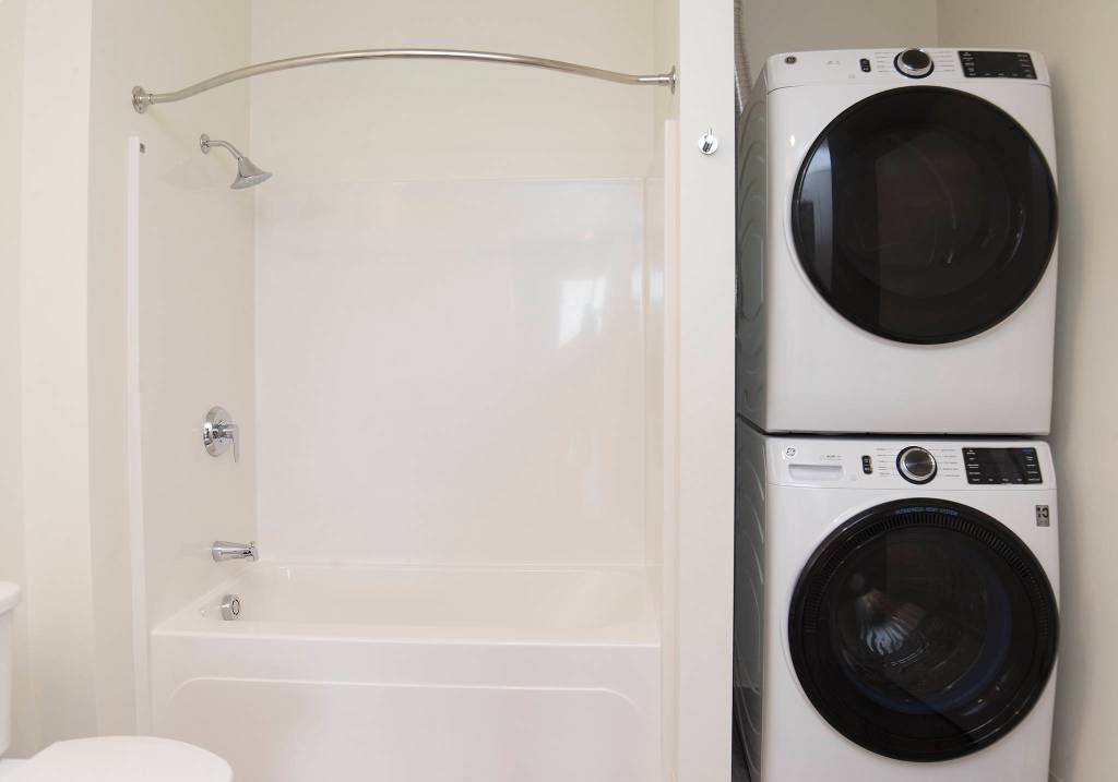 A stacked washer and dryer set is seen in one of 135 apartments available in the Waterfront Place Apartments in Everett. (Andy Bronson / The Herald)