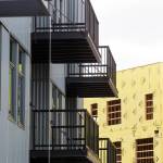 The Waterfront Place, which has 135 apartments, is being shown and leased at its Port of Everett location. Residents of the north building (left) could begin moving in by May 15. The south building (right), which burned down in 2020, is being rebuilt and will open next year with another 131 apartments. (Andy Bronson / The Herald)