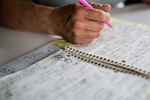 Rachael Kendrick shows a spiral notebook filled with names and phone numbers of places she has applied for jobs on Friday, April 30, 2021 in Stanwood, Wash. (Olivia Vanni / The Herald)