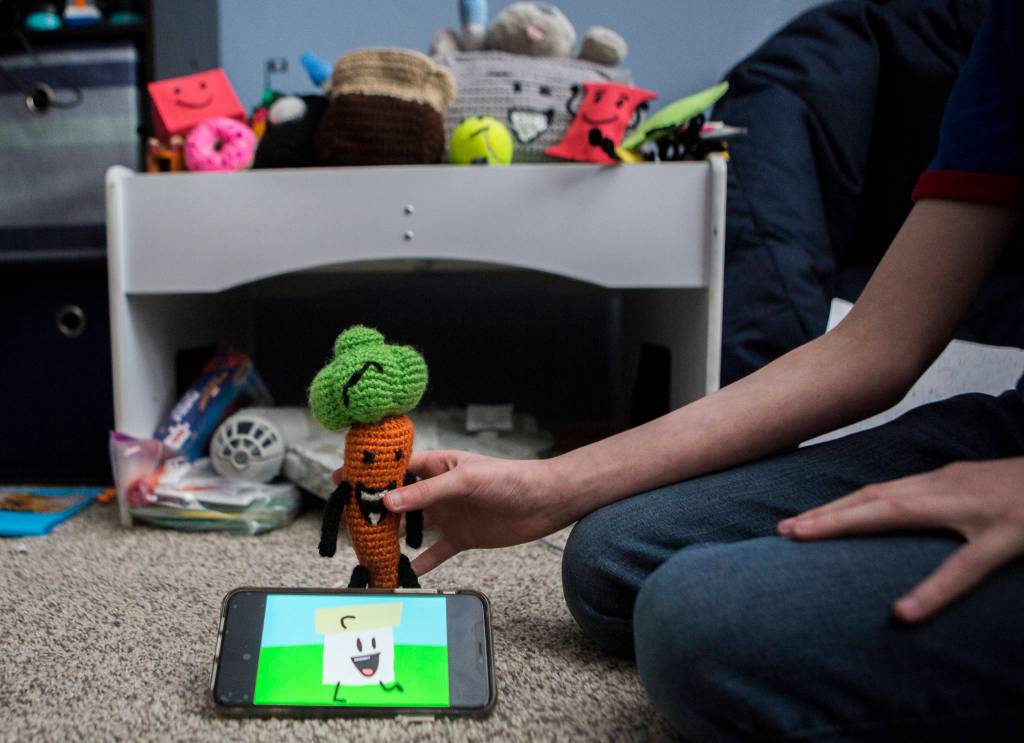 David Stowells animated YouTube series plays while he shows off some of his characters. (Olivia Vanni / The Herald)