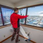 From the third floor crows nest of its new building in the Port of Everetts South Marina, Everett Yacht Club Commodore John Seger points out what will be the clubs dock, Tuesday in Everett. (Andy Bronson / The Herald)