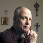 George Vasil, author of “The Lance,” in his home office in Arlington. (Andy Bronson / The Herald)