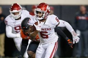 Oklahoma cornerback Tre Brown (6) carries during an NCAA college football game against Oklahoma State in Stillwater, Okla., Saturday, Nov. 30, 2019. (AP Photo/Sue Ogrocki)