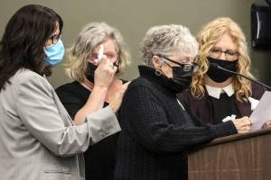 Daughters Erin Van Ry, (left) Jennifer Parks listens their mother Kathy Parks addresses the court with Nanci Bidondo (far right) as Thursday afternoon at the Snohomish County Building on May 13, 2021.  (Kevin Clark / The Herald)