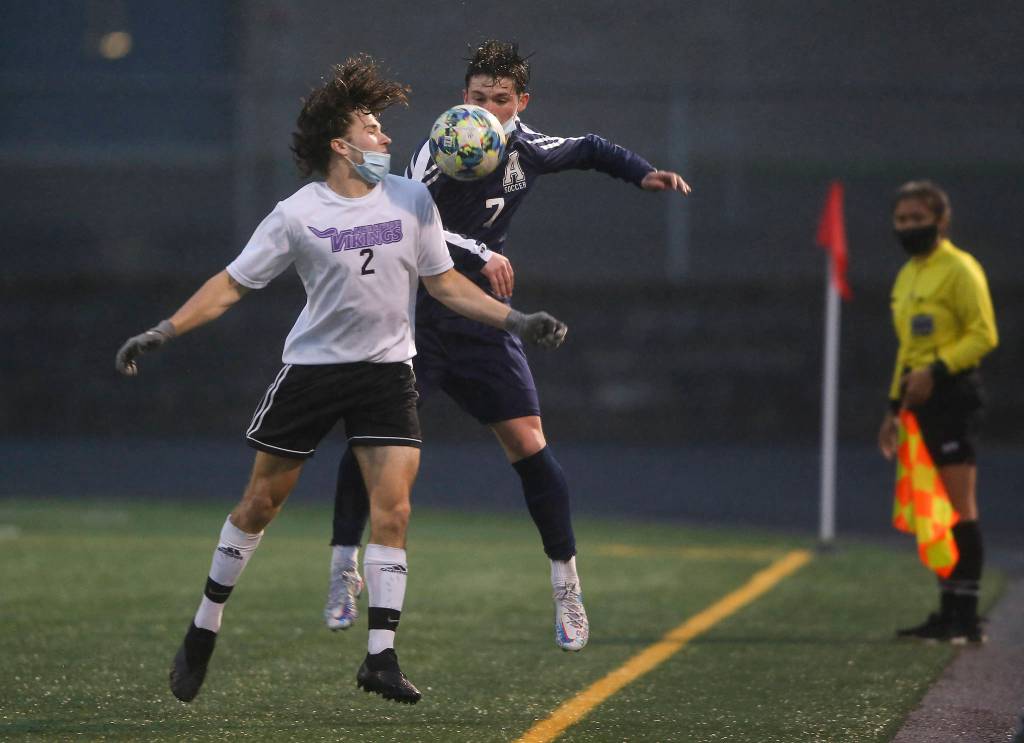 Lake Stevens Lucas Joehnk and Arlingtons Cameron Mooring battle to keep the ball in play as Arlington beat Lakes Stevens 2-1 in a boys soccer match on Monday, May 3, 2021 in Arlington, Washington. (Andy Bronson / The Herald)