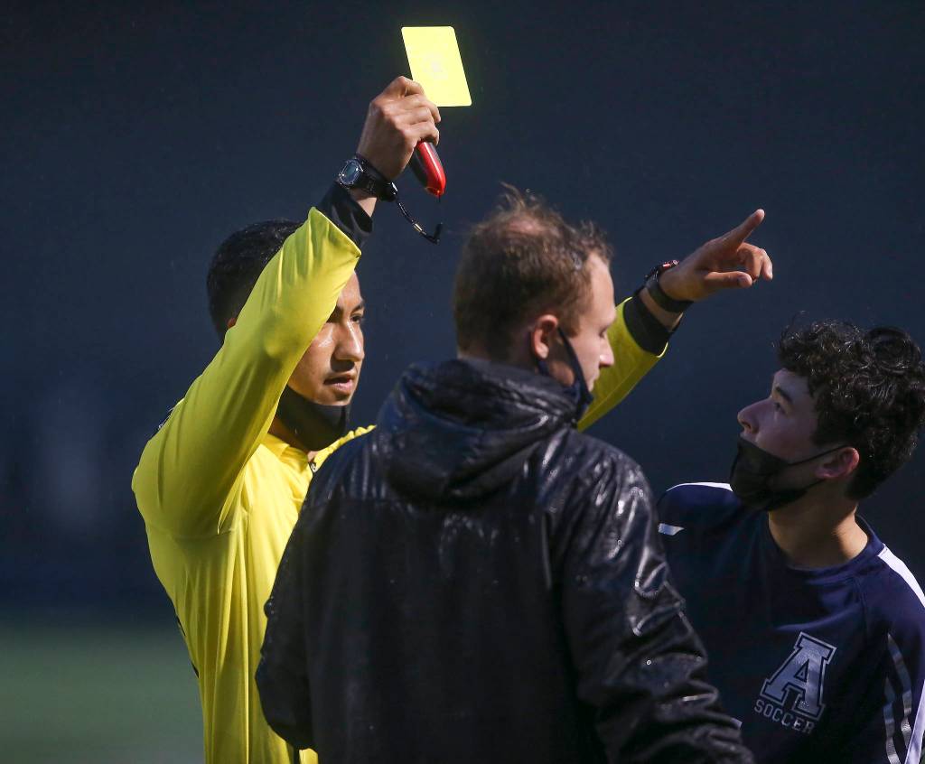 Arlingtons Kiyoshi Hall is given a yellow card in the second half as Arlington beat Lakes Stevens 2-1 in a boys soccer match on Monday, May 3, 2021 in Arlington, Washington. (Andy Bronson / The Herald)
