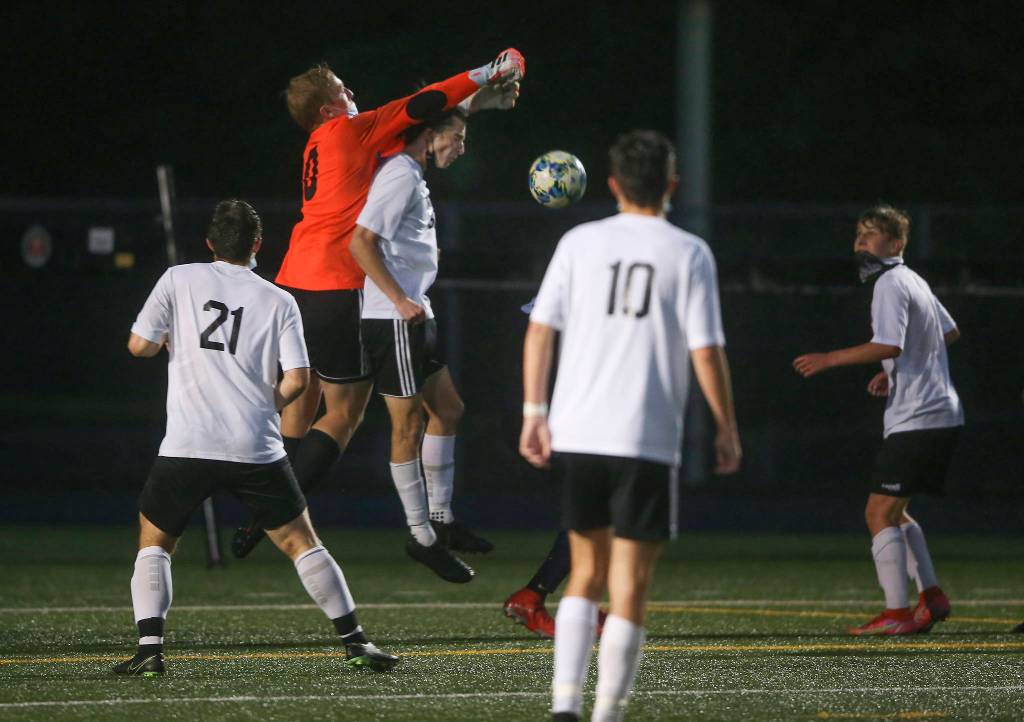 Lake Stevens Tanner Jordan punches the ball away during a corner kick as Arlington beat Lakes Stevens 2-1 in a boys soccer match on Monday, May 3, 2021 in Arlington, Washington. (Andy Bronson / The Herald)