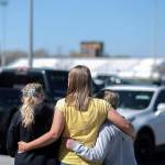 People embrace outside after a shooting at Rigby Middle School in Rigby, Idaho, on Thursday. Two students and a custodian were injured. A sixth-grade girl has been taken into custody. (John Roark /The Idaho Post-Register via AP)