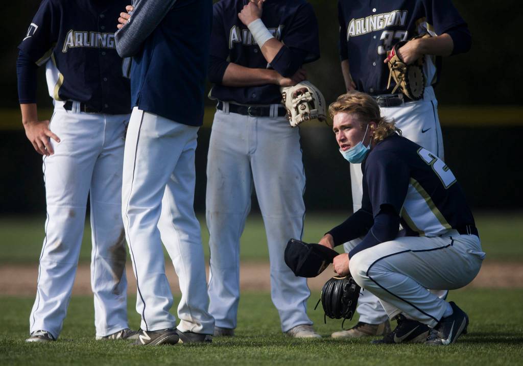 Arlingtons Jacob Burkett waits as the next pitcher warms up during a game against Marysville Getchell on May 7, 2021, in Arlington. (Olivia Vanni / The Herald)