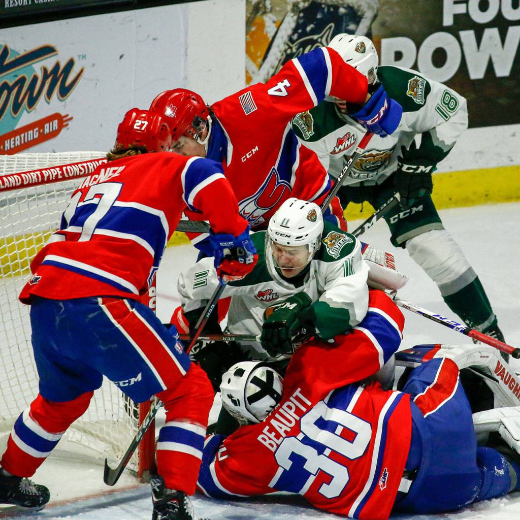 The Silvertips Jacob Wright struggles with the Chiefs defenders during a game on May 7, 2021, at Angel of the Winds Arena in Everett. (Kevin Clark / The Herald)