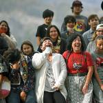 Linda Desautel, center in white, looks skyward and cheers with friends and Colville Confederated Tribe members as they rally in support of her husband Rick Desautel, whose case in the Canadian Supreme court arguing for the Sinixt peoples' right to hunt traditional lands in Canada was first heard, on Thursday, Oct. 8, 2020, near Kettle Falls, Wash. It's been 50 years since the Confederated Tribes of the Colville Reservation voted against termination, effectively ending the federal government's experiment in abrogating treaties, eliminating funding and "freeing the Indians" from the Bureau of Indian Affairs. More than 100 tribes were terminated by the United States — but not one after the 12 bands that make up the reservation in Washington state crushed the idea at the ballot box. (Tyler Tjomsland/The Spokesman-Review via AP)