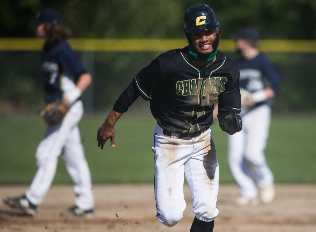 Marysville Getchells Malakhi Knight runs to third base for a steal during the game against Arlington on Friday, May 7, 2021 in Arlington, Wash. (Olivia Vanni / The Herald)