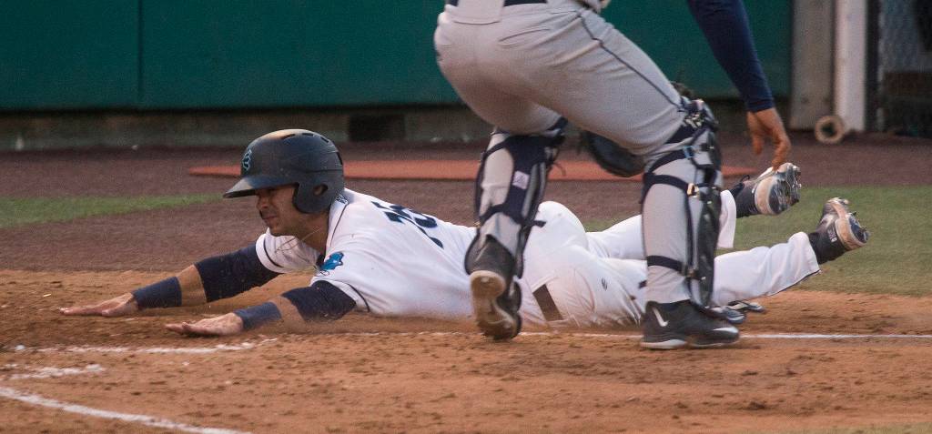Aquasoxs David Frick slides across home plate for a run as the Everett Aquasox beat the Tri-City Dust Devils in a home opening game at Funko Field on Tuesday, May 11, 2021 in Everett, Washington. (Andy Bronson / The Herald)