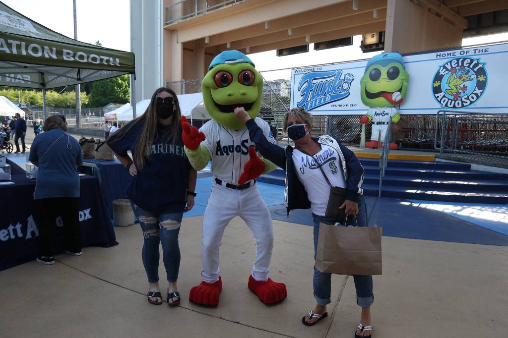 Fans get photos with Webbly the mascot before the Everett Aquasox beat the Tri-City Dust Devils on May 11, 2021, at Funko Field in Everett. (Andy Bronson / The Herald)
