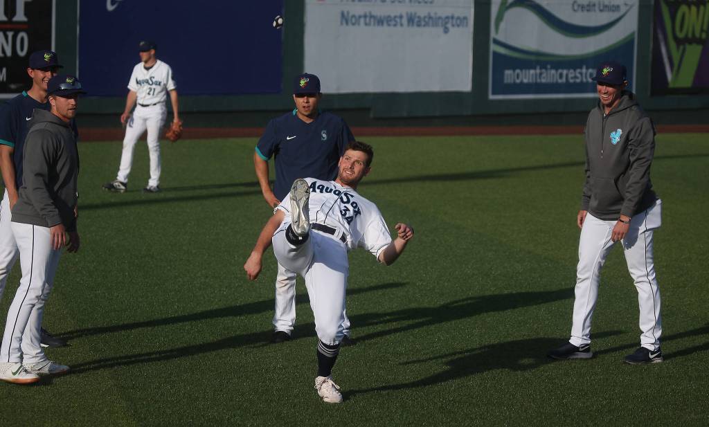 The AquaSoxs Brendan McGuigan kicks a hacky-sack to warm up with teammates before a game against the Dust Devils on May 11, 2021, at Funko Field in Everett. (Andy Bronson / The Herald)