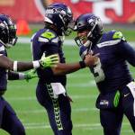 Seahawks quarterback Russell Wilson (right) celebrates after a touchdown against the 49ers with quarterback Geno Smith (center) and running back Alex Collins during the second half of a game Jan. 3, 2021, in Glendale, Ariz. (AP Photo/Rick Scuteri)