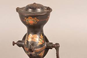 This strange looking cast-iron tool is a coffee grinder. Beans go in the top, the lid is put in place and the beans are ground and drop into the lower section mounted on a wooden base. It sold for $413 a few years ago. (Cowles Syndicate Inc.)