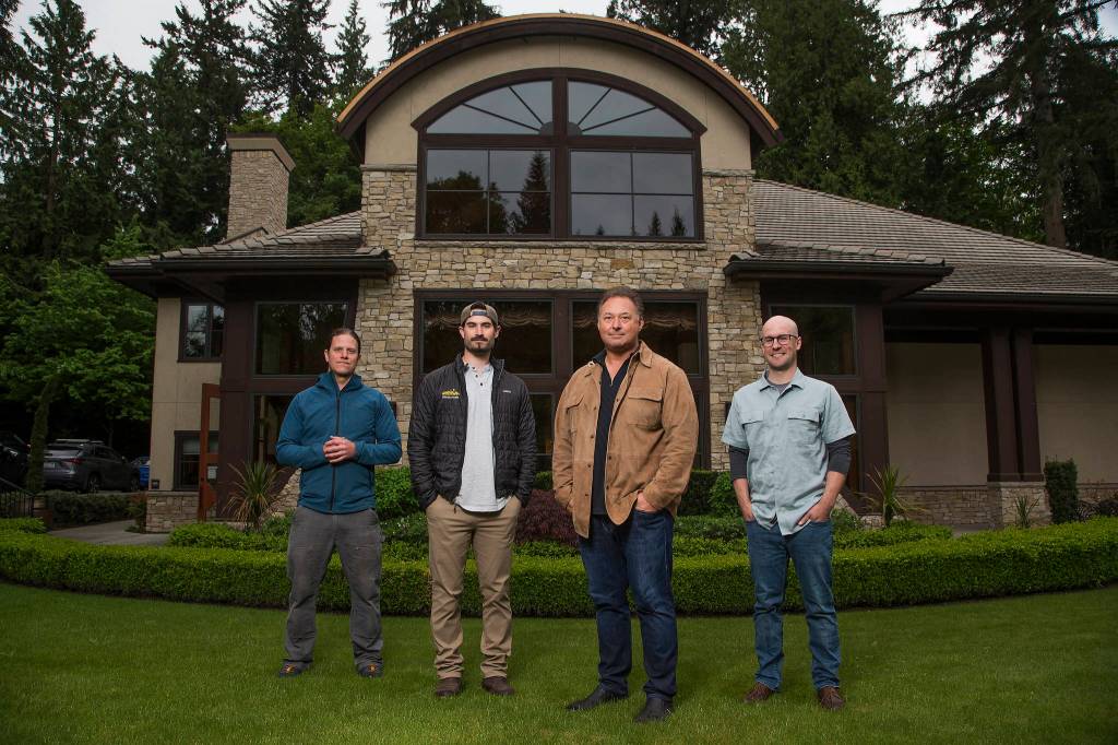 Assistant winemakers Hal Iverson, left, and Jeff Schmidt with Paul Golitzin, president and director of winemaking, with winemaker Alex Stewart, right, at Quilceda Creek on Monday, May 17, 2021 in Snohomish, Washington. (Andy Bronson / The Herald)