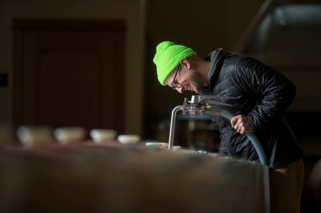 Winemaker Alex Stewart fills barrels with Columbia Valley Red at Quilceda Creek on Monday, May 17, 2021 in Snohomish, Washington. (Andy Bronson / The Herald)