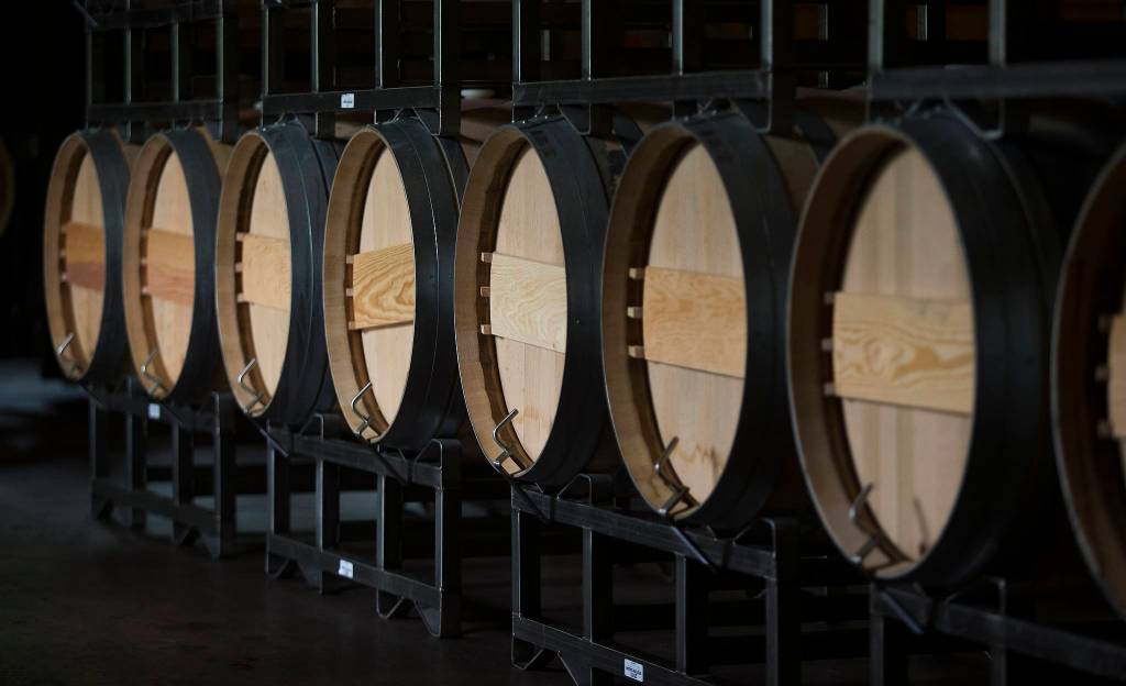 Barrels are lined up and stacked in the cellar at Quilceda Creek on Monday, May 17, 2021 in Snohomish, Washington. (Andy Bronson / The Herald)