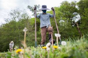 Libby Reed loosens soil with a broadfork at Orange Star Farm on Thursday, May 6, 2021 in Monroe, Wash. (Olivia Vanni / The Herald)