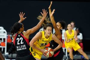 FILE - Seattle Storm forward Breanna Stewart (30) gets between Las Vegas Aces center A'ja Wilson (22) and forward Cierra Burdick (11) during the second half of Game 3 of basketball's WNBA Finals in Bradenton, Fla., in this Tuesday, Oct. 6, 2020, file photo. The WNBA will tip off its 25th season on Friday, May 14, 2021. (AP Photo/Chris O'Meara)