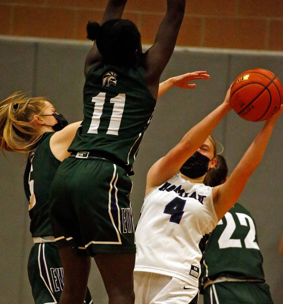 Kamiaks Hayley Gallaher (4) is trapped by Edmonds-Woodways Ella Wallace and Kaddy Kongira during a game on May 14, 2021, at Kamiak High School in Mukilteo. (Kevin Clark / The Herald)