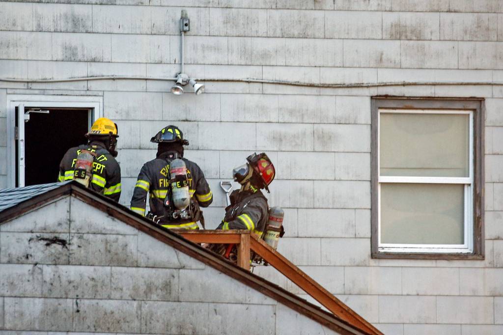 Firefighter douse the flames at the vacant NOAA Research Station Friday evening in Mukilteo. (Kevin Clark / The Herald)