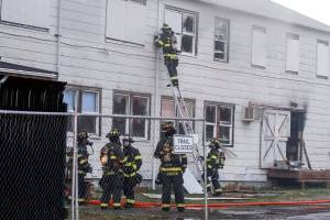 Firefighters douse the flames at the NOAA Fisheries Building Friday evening in Mukilteo on May 14, 2021.  (Kevin Clark / The Herald)