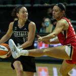 Las Vegas Aces Dearica Hamby kicks her leg out while guarding Seattle Storms Sue Bird during a game on May 15, 2021, in Everett. (Olivia Vanni / The Herald)