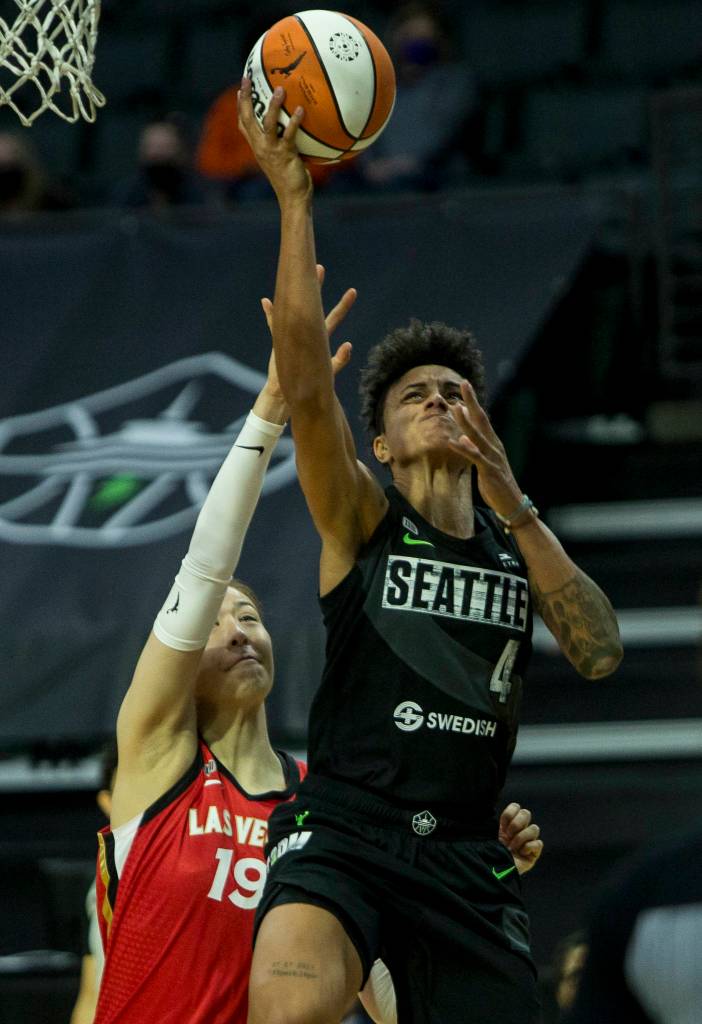 Seattle Storms Candice Dupree makes a layup past Las Vegas Aces JiSu Park during a game on May 15, 2021, in Everett. (Olivia Vanni / The Herald)